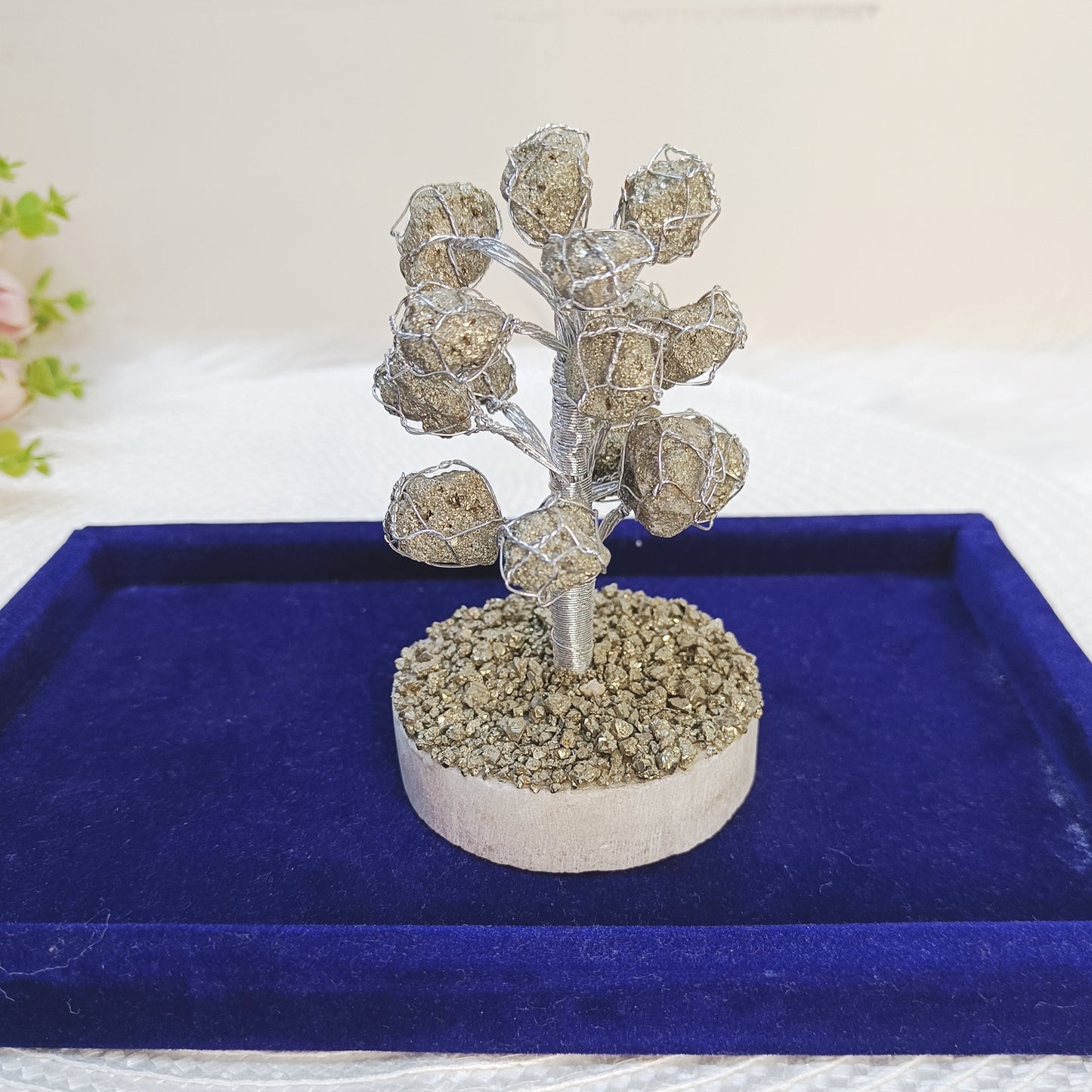 Decorative Pyrite gemstone tree with raw natural stones and silver wire base for home décor.