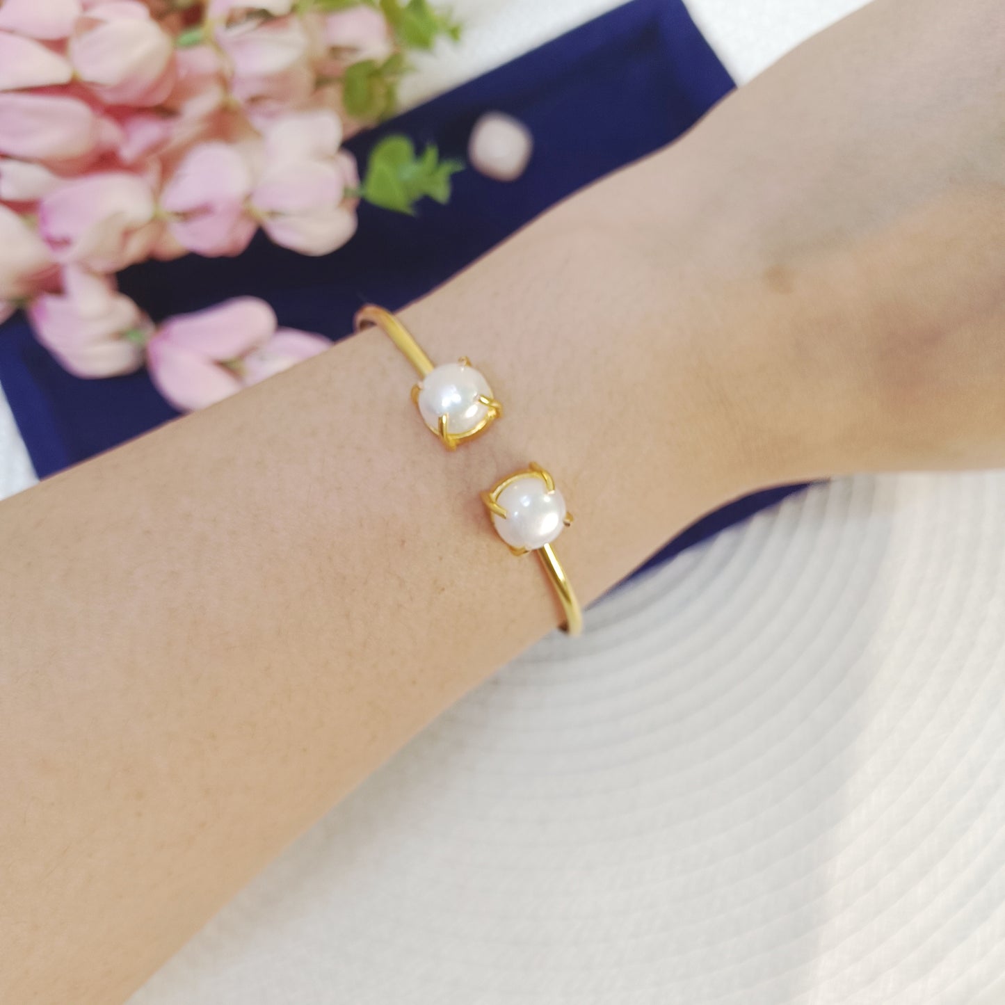 Elegant adjustable Freshwater pearl cuff bangle in gold plated brass on a wrist