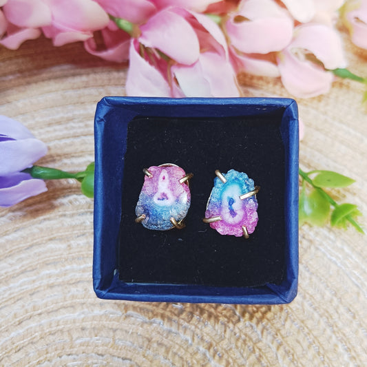 Close-up of Solar Quartz earrings showing natural druzy texture and colorful crystal center.