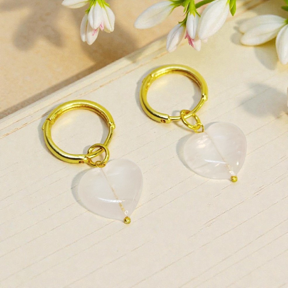 Gold hoop earrings with heart shaped pink stone