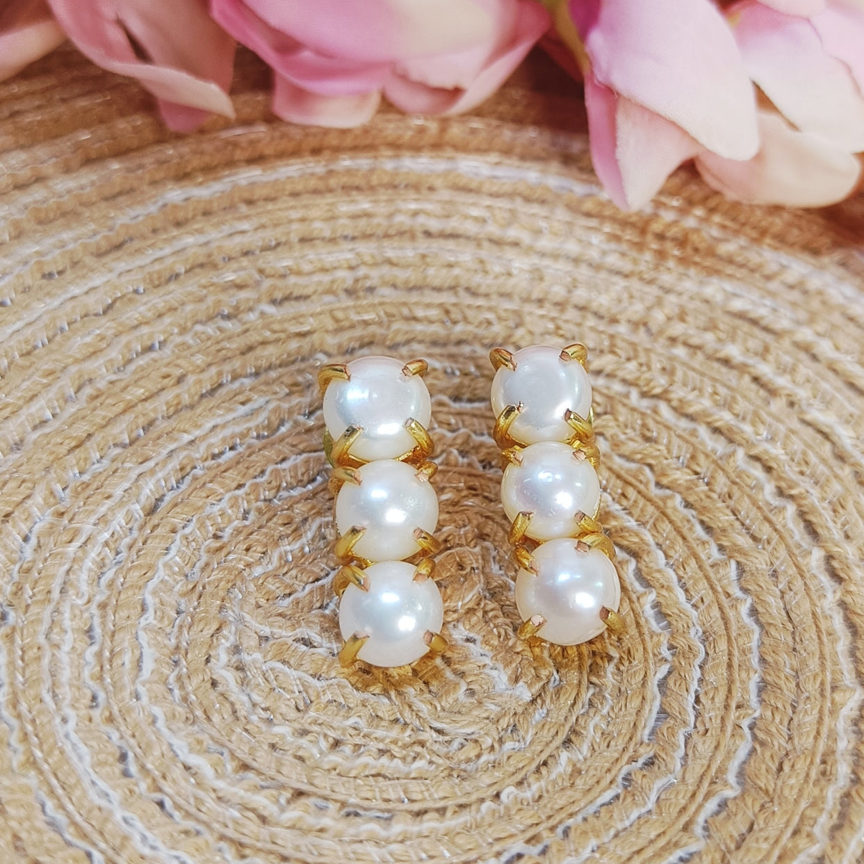 3 line Freshwater pearl drop line earrings kept on a jute mat, everyday elegance pearl