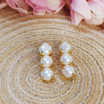 3 line Freshwater pearl drop line earrings kept on a jute mat, everyday elegance pearl