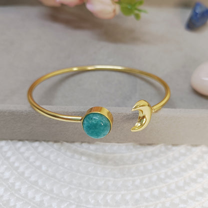 Close-up of Amazonite cuff bangle showing brass moon charm and gold-plated finish. 