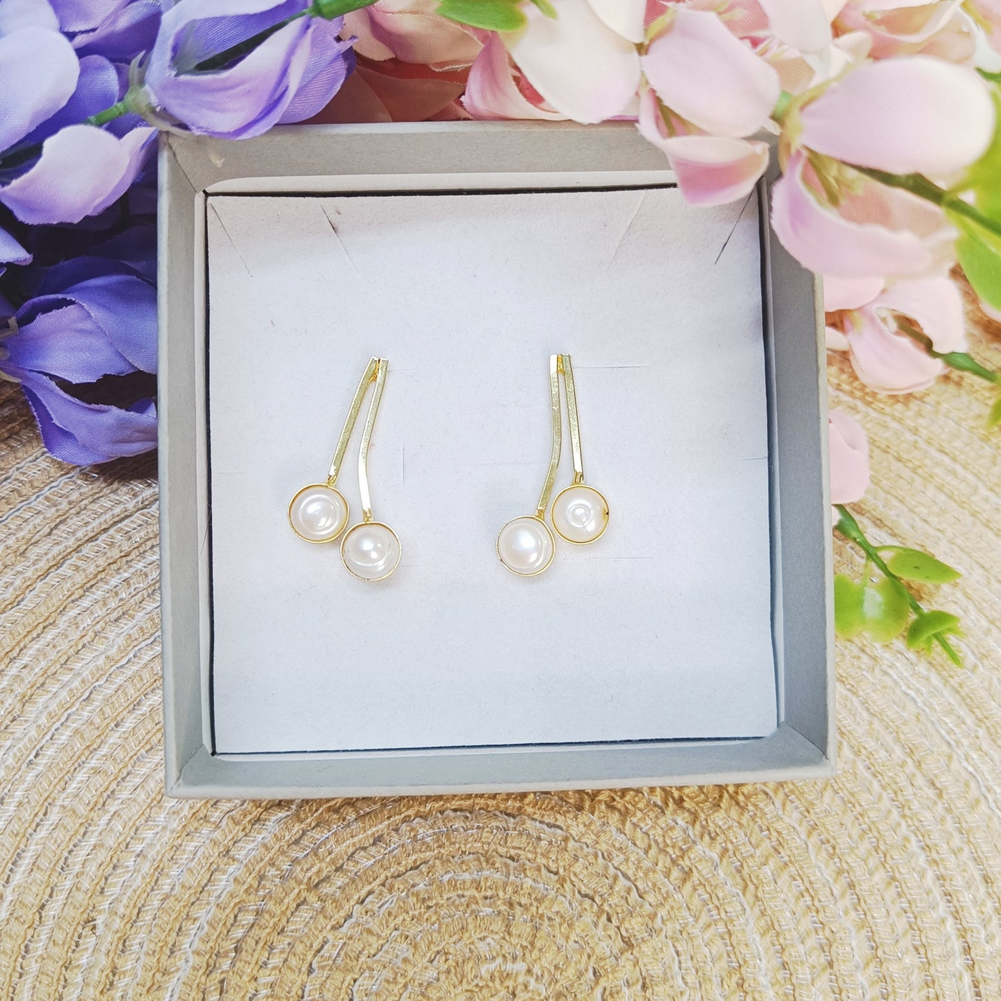 Dual Pearl Curve Earrings in gold finish displayed in jewelry box – minimalist double pearl design by Gemsara.