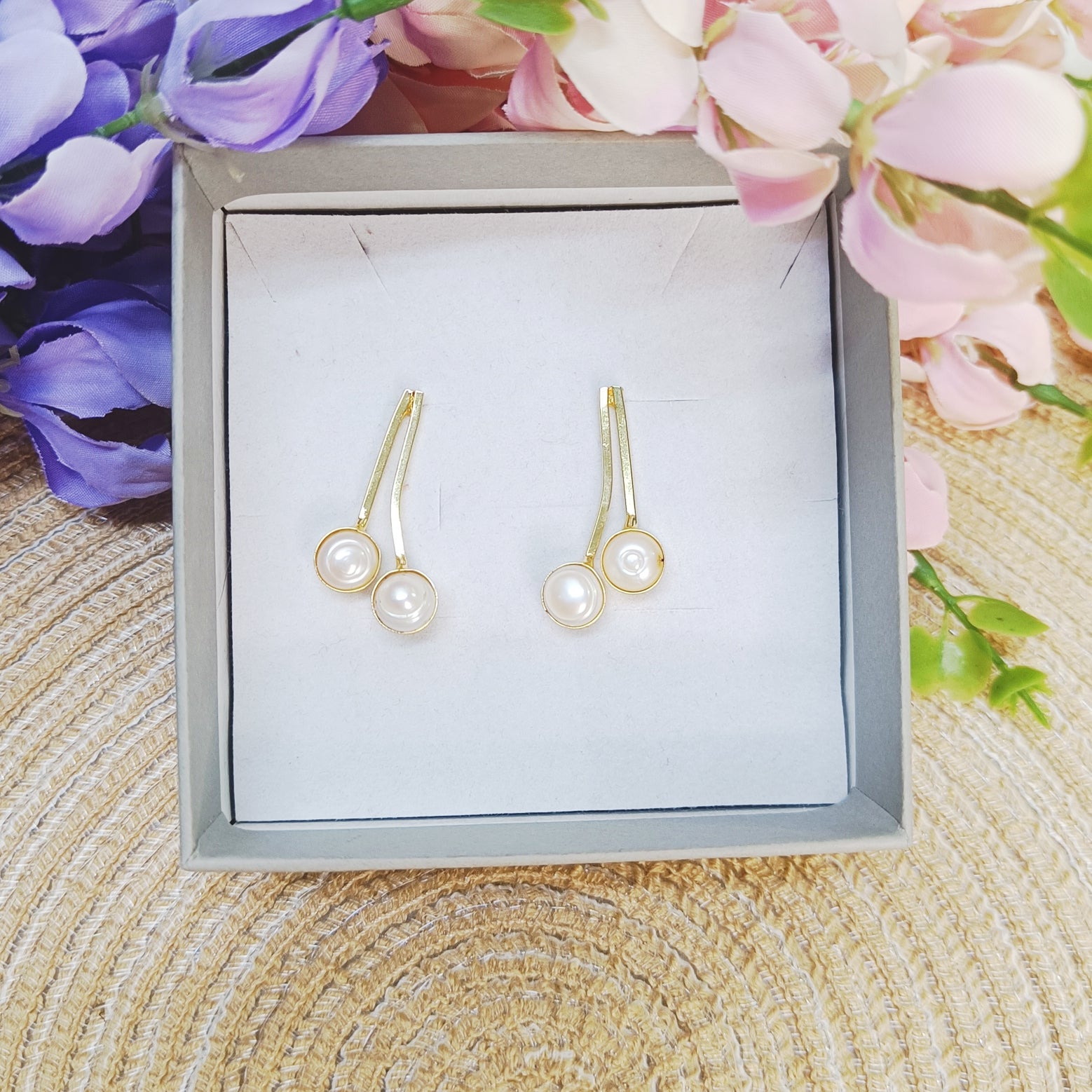 Dual Pearl Curve Earrings in gold finish displayed in jewelry box – minimalist double pearl design by Gemsara.