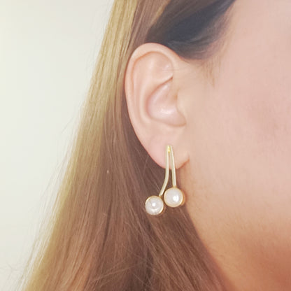 Model wearing Dual Pearl Curve Earrings – elegant pearl in gold tone jewelry for everyday style.