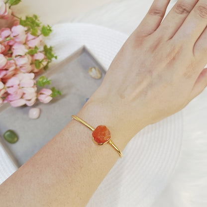 Carnelian stone bangle with golden adjustable cuff, natural gemstone jewelry.