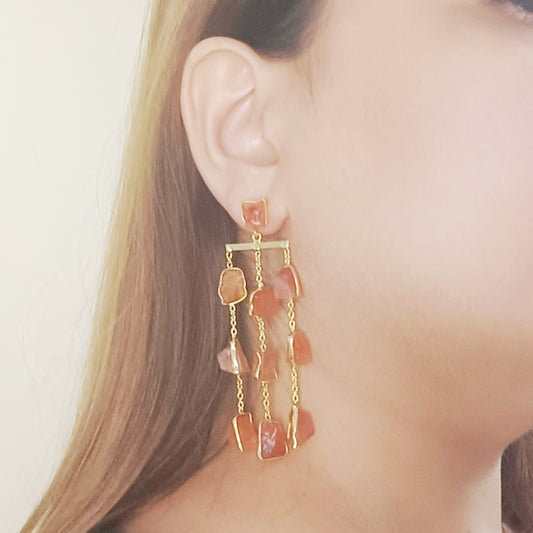 Woman wearing long carnelian gemstone earrings — Gemsara handcrafted jewellery