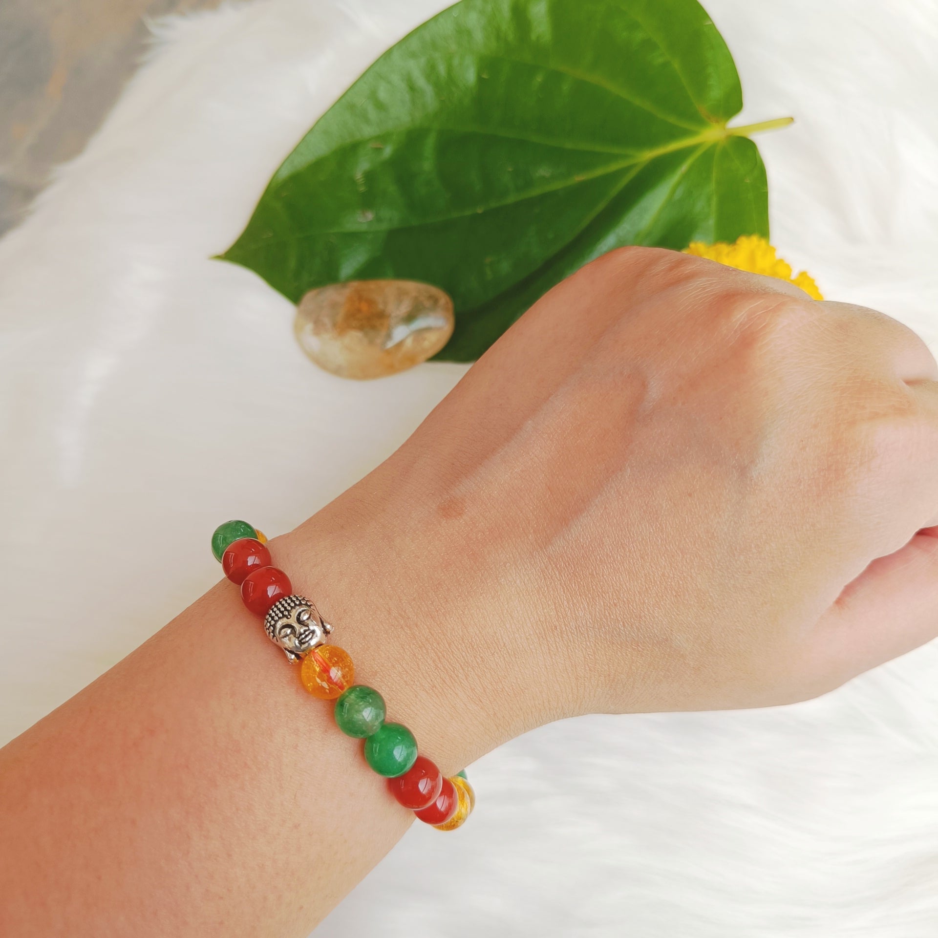 Citrine quartz, carnelian and green aventurine combination bracelet worn on wrist
