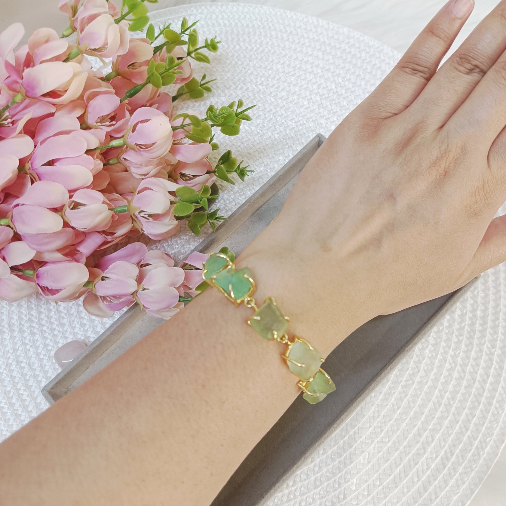 raw flourite brass bracelet, raw crystal brass bracelet on wrist, light green raw stone bracelet on a wrist
