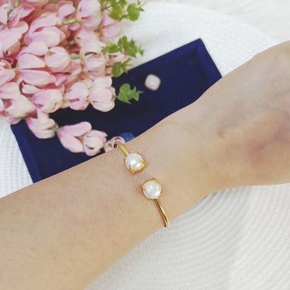 Adjustable Freshwater pearl cuff bangle in gold plated brass on a wrist