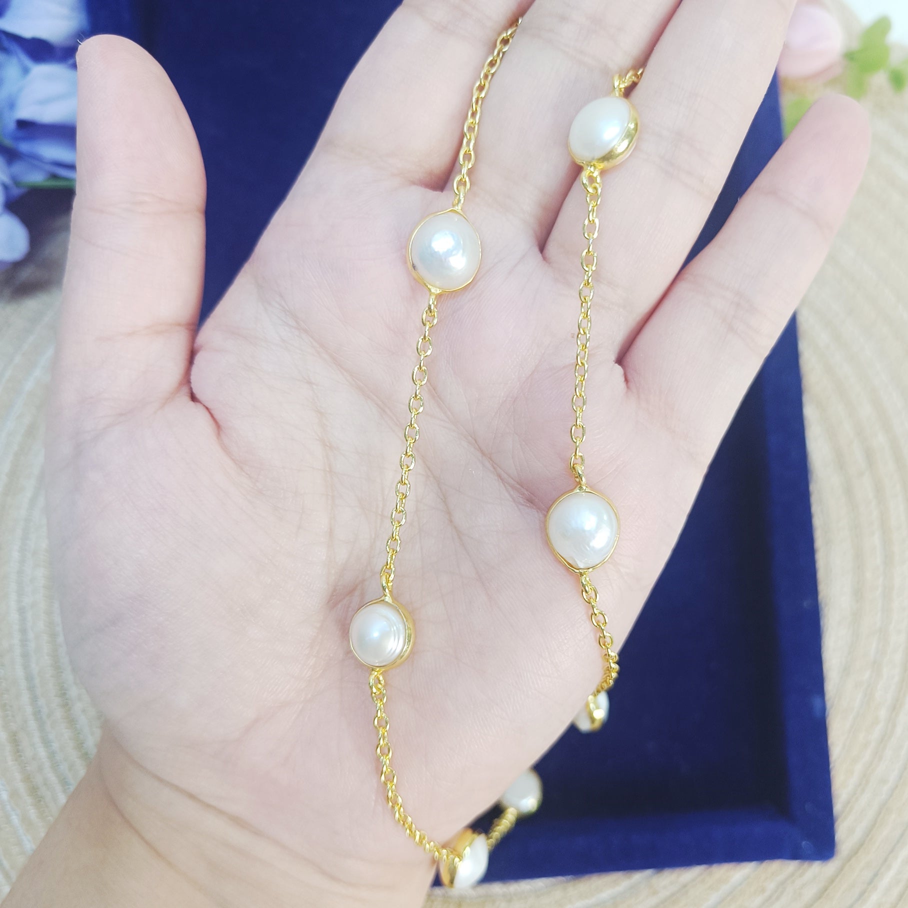 Close-up of Freshwater Pearl Long Chain Necklace in gold plating held in hand – Gemsara Jewelry