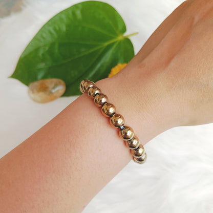 Handcrafted Golden Hematite Bracelet with a metallic gold shine — designed to ground your energy, boost focus, and radiate confidence by Gemsara.