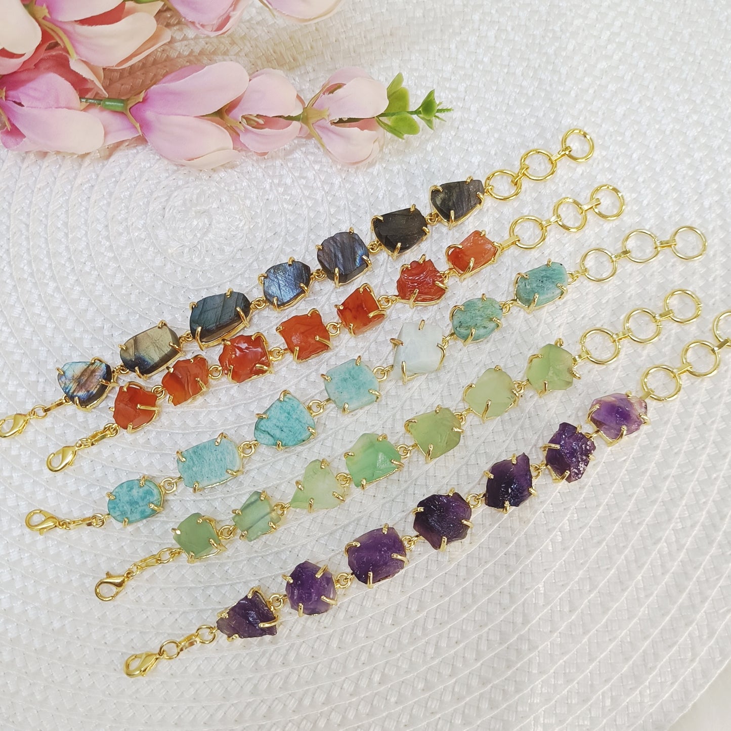 Raw uncut crystal bracelets in carnelian, labradorite, amethyst, fluorite, and amazonite on brass bands. Multicolor stone brass bracelet