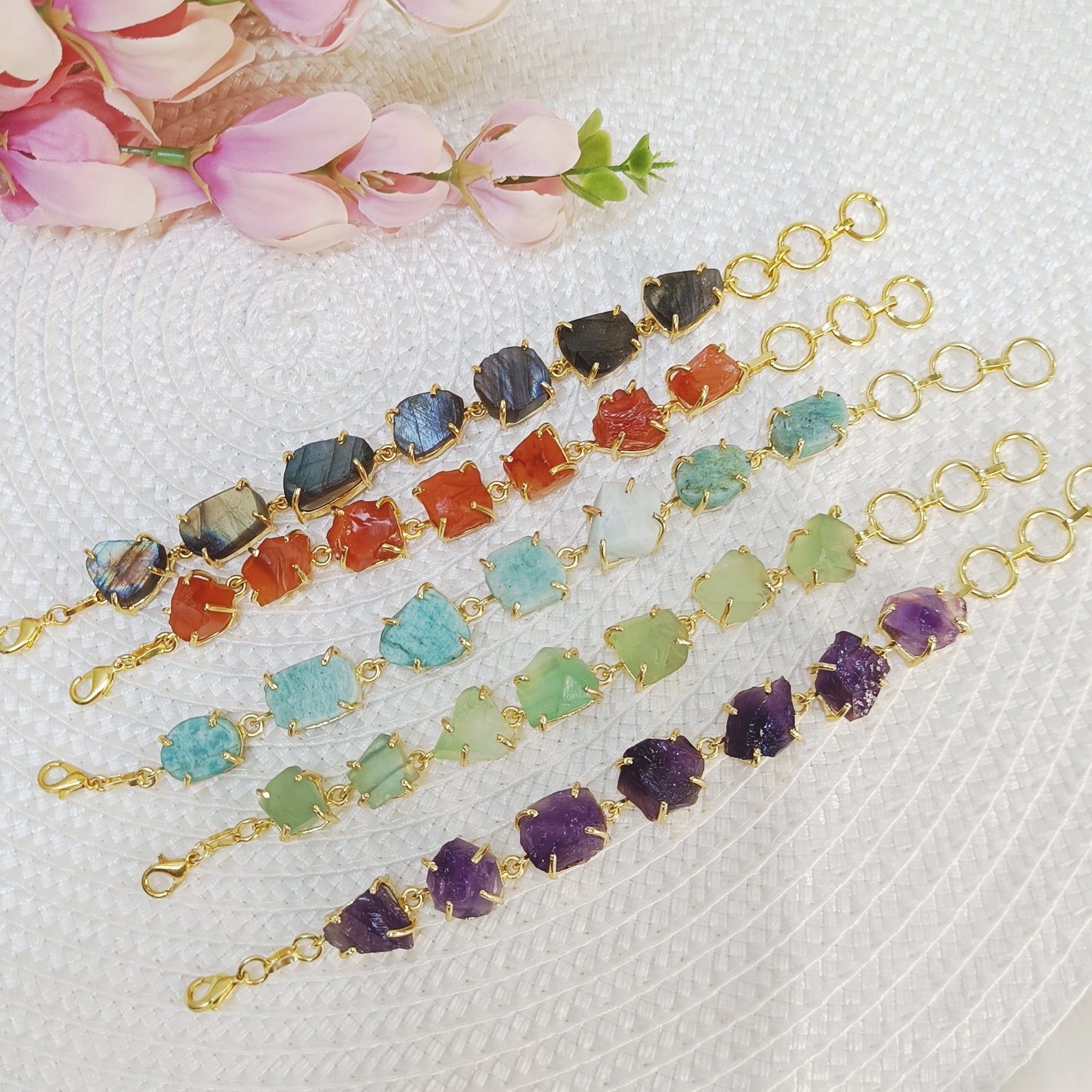 Raw uncut crystal bracelets in carnelian, labradorite, amethyst, fluorite, and amazonite on brass bands. Multicolor stone brass bracelet