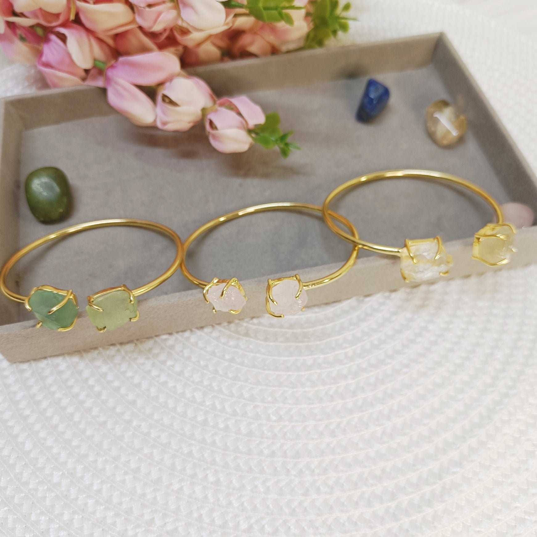 Natural real crystal cuff bangles with pink, green, and yellow stones in golden adjustable brass. 