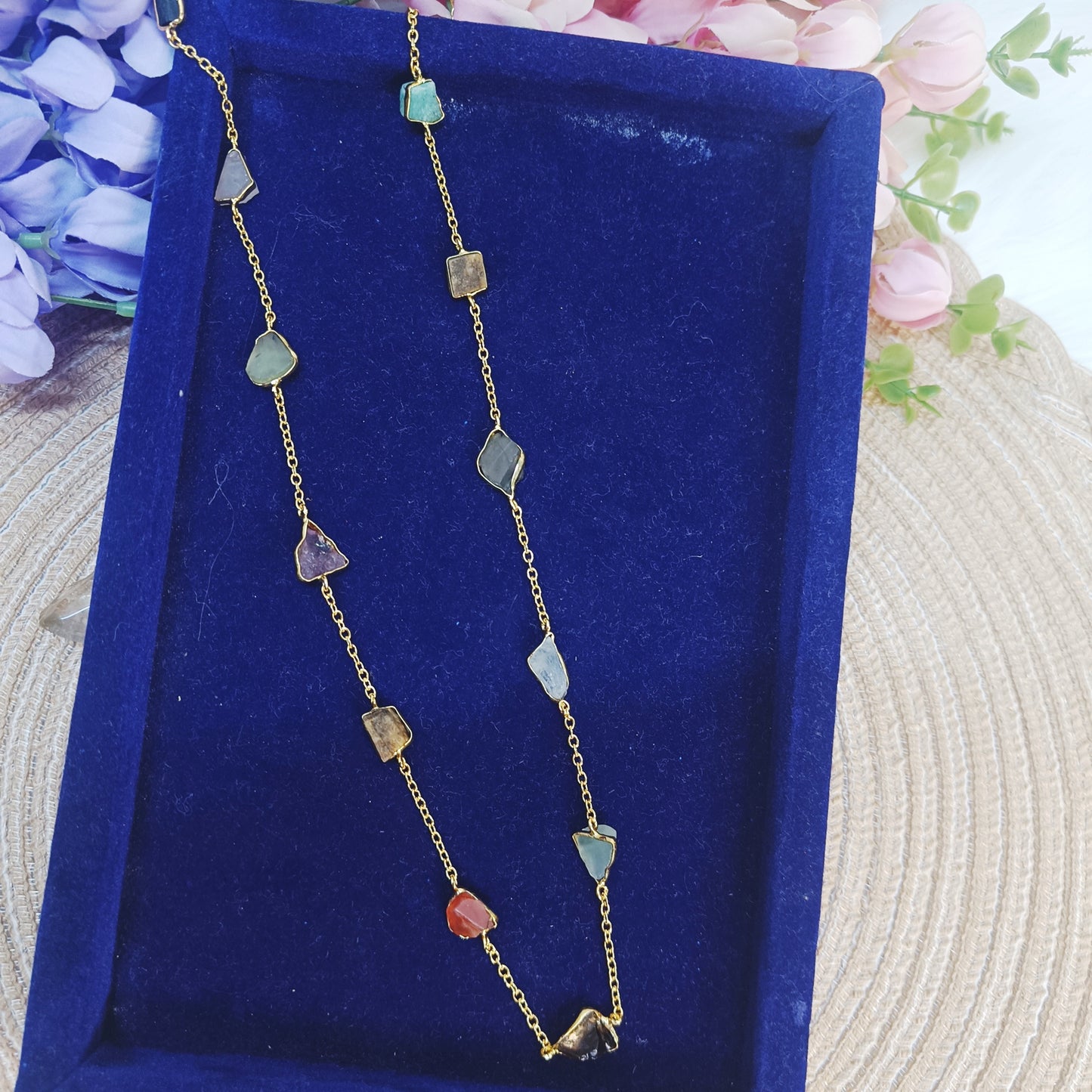 Close-up of multicolor gemstone long chain on navy velvet tray – Gemsara Jewelry