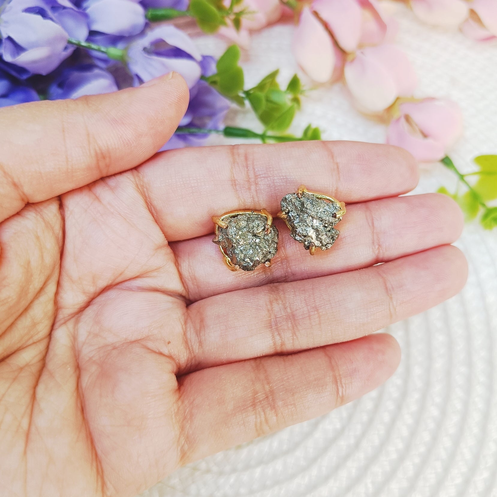 Raw Pyrite Stud Earrings in gold-plated setting on hand – Gemsara