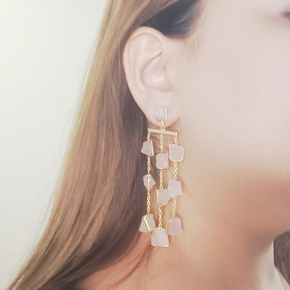 Close-up of a woman wearing pink stones earrings, gold plated rose quartz festive earrings